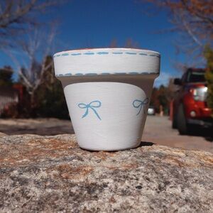 Blue bows clay pot